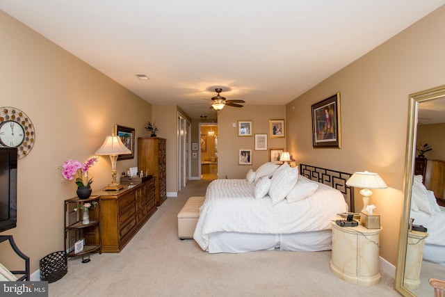 carpeted bedroom with ceiling fan and ensuite bathroom