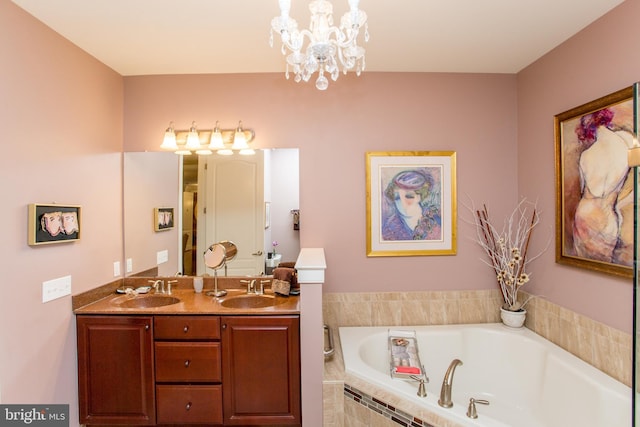 bathroom featuring vanity, a relaxing tiled tub, and a notable chandelier