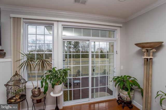 doorway featuring hardwood / wood-style floors and crown molding