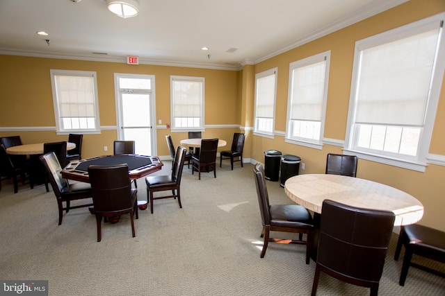 dining room featuring light colored carpet and ornamental molding