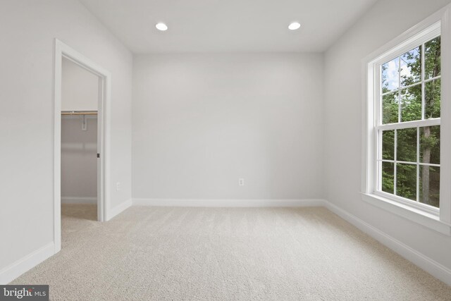14496 Aurora Dr, Woodbridge, VA 22193 - unfurnished bedroom featuring light carpet, multiple windows, a spacious closet, recessed lighting, and baseboards