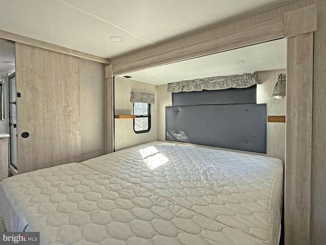 unfurnished bedroom with wood walls