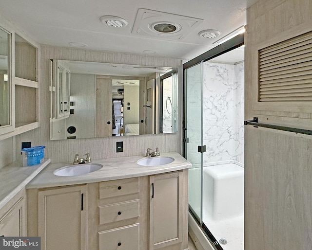 bathroom featuring vanity, a shower with shower door, and decorative backsplash