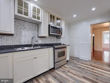 519 Locust St, Columbia, PA 17512 - kitchen featuring appliances with stainless steel finishes, dark countertops, a sink, decorative backsplash, and recessed lighting
