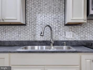 519 Locust St, Columbia, PA 17512 - kitchen featuring a sink, dark countertops, white cabinets, and tasteful backsplash