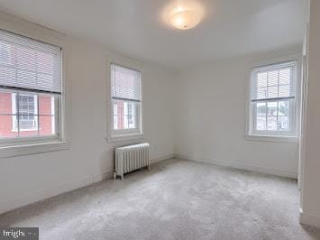519 Locust St, Columbia, PA 17512 - empty room featuring radiator, plenty of natural light, and carpet floors