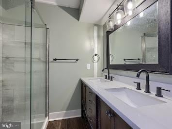 519 Locust St, Columbia, PA 17512 - bathroom with a stall shower, baseboards, double vanity, and wood finished floors