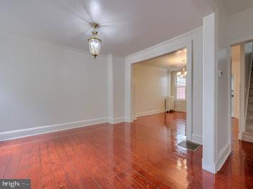 519 Locust St, Columbia, PA 17512 - unfurnished room featuring ornamental molding, wood finished floors, stairs, and baseboards