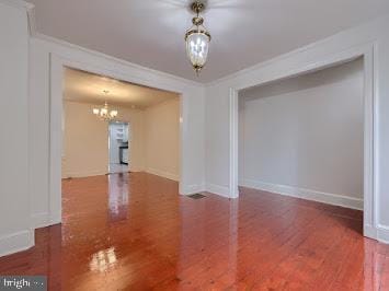 519 Locust St, Columbia, PA 17512 - empty room featuring a chandelier, wood finished floors, baseboards, and crown molding