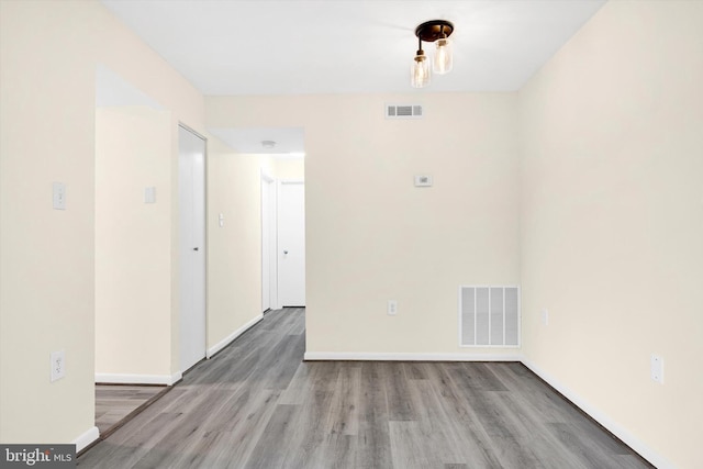 unfurnished room with hardwood / wood-style floors