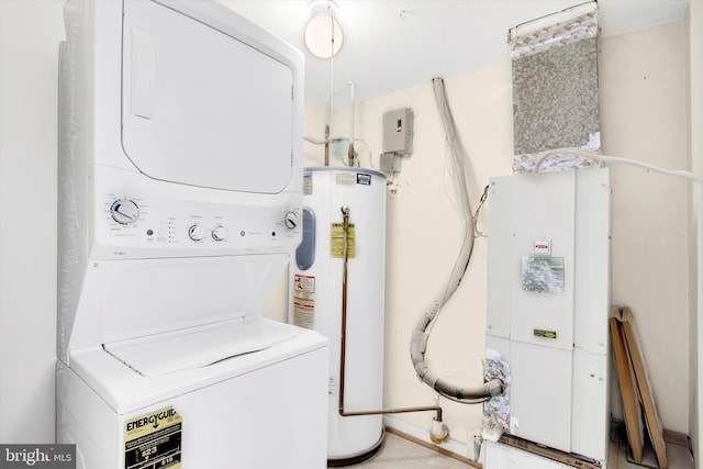 washroom with stacked washer / drying machine and water heater