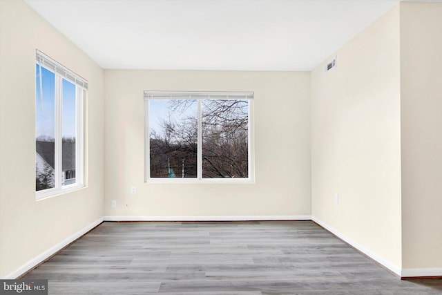 unfurnished room with wood-type flooring