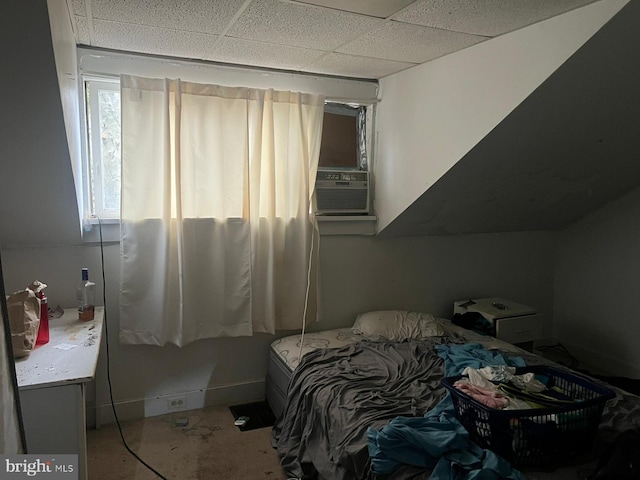 bedroom with cooling unit and a paneled ceiling