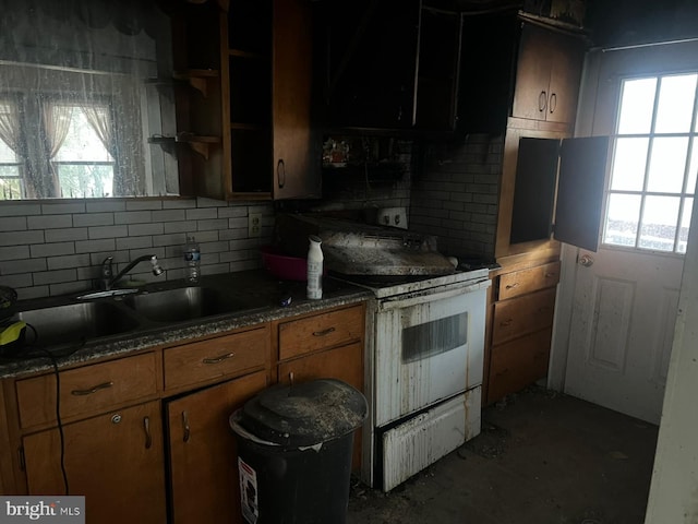 kitchen with sink, decorative backsplash, and white range with electric stovetop