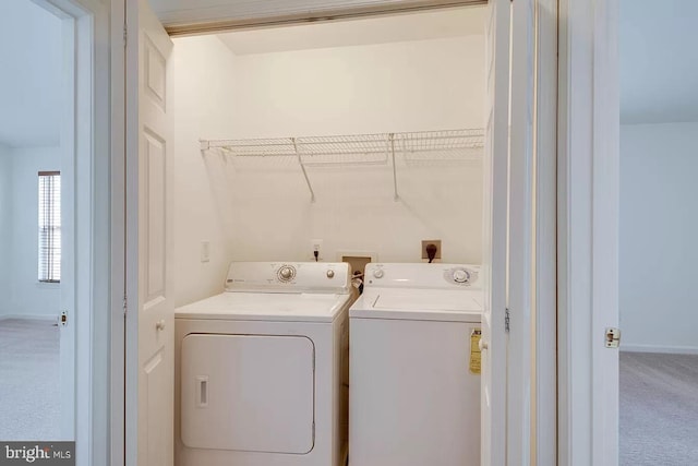 laundry area with carpet floors and washing machine and dryer