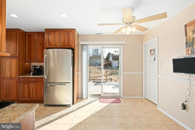 kitchen featuring ceiling fan, stainless steel fridge, and light tile patterned floors