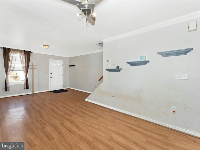 entryway featuring hardwood / wood-style flooring, ornamental molding, and ceiling fan