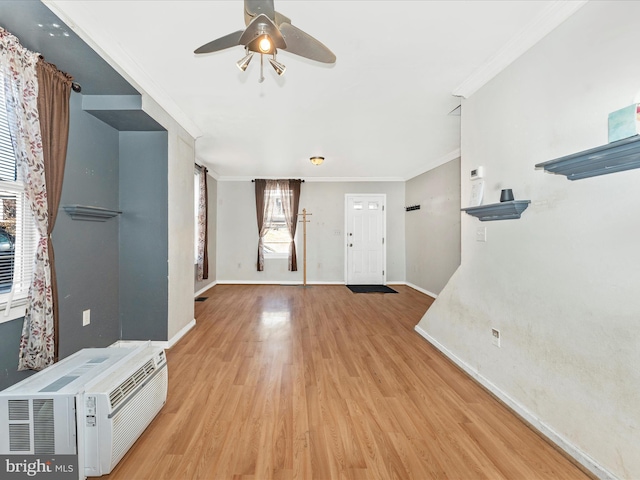 entryway with a wall mounted air conditioner, crown molding, light hardwood / wood-style flooring, and ceiling fan