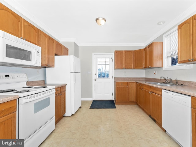 kitchen featuring white appliances, ornamental molding, and sink