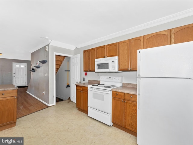 kitchen featuring white appliances and ornamental molding