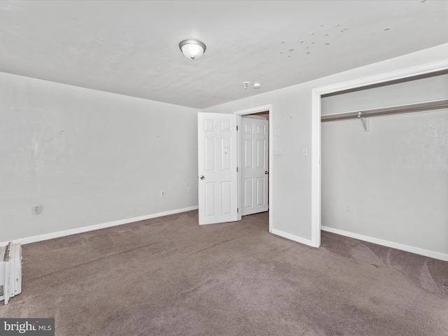 unfurnished bedroom featuring carpet floors and a closet