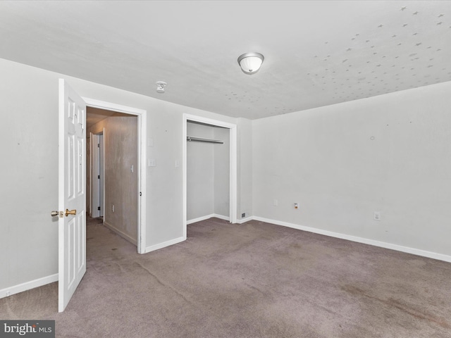 unfurnished bedroom with carpet floors and a closet