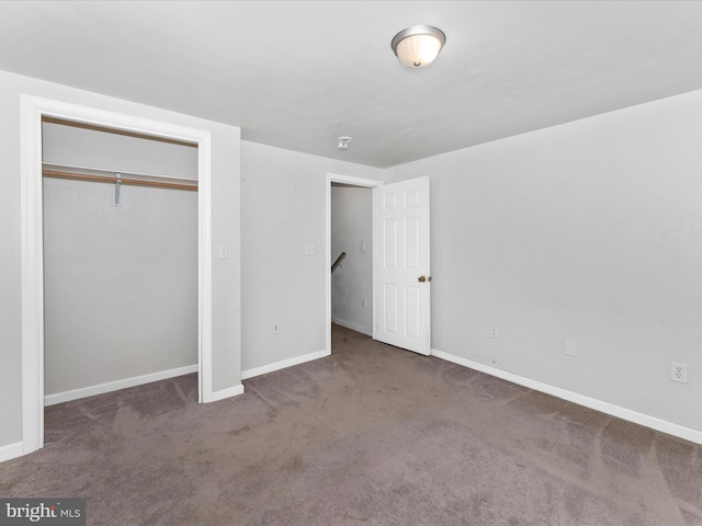 unfurnished bedroom with carpet floors and a closet