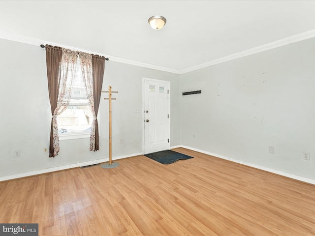 foyer entrance featuring hardwood / wood-style floors and ornamental molding