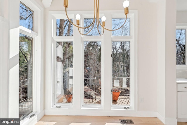 unfurnished sunroom with a notable chandelier