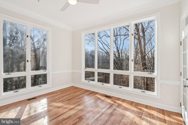 unfurnished sunroom featuring ceiling fan