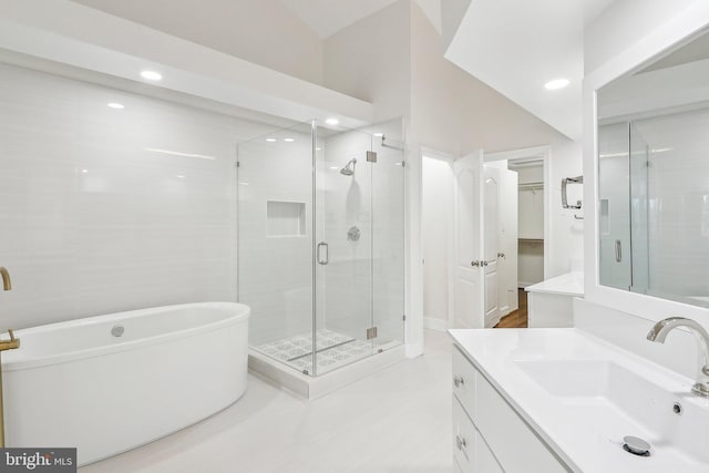 bathroom with vanity and independent shower and bath