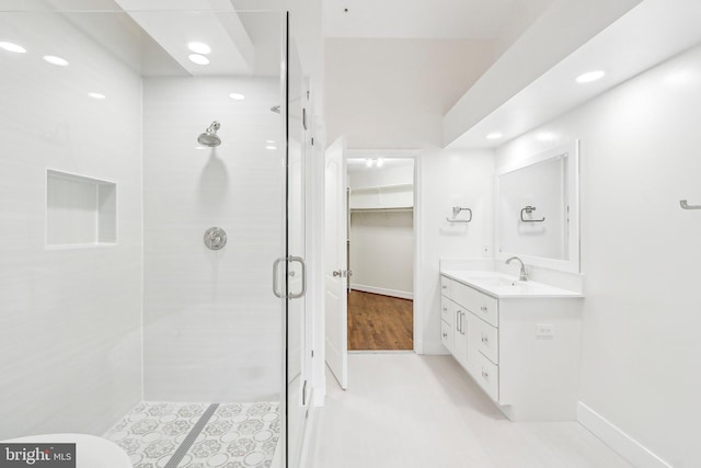 bathroom featuring vanity and a shower with shower door