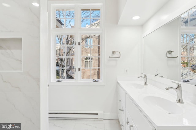 bathroom featuring vanity, a wealth of natural light, and a baseboard heating unit