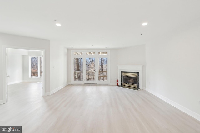 unfurnished living room with light wood-type flooring