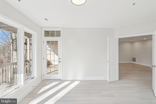 empty room with light hardwood / wood-style floors