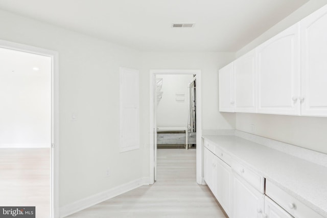 corridor featuring light hardwood / wood-style floors