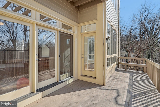 view of exterior entry with a deck