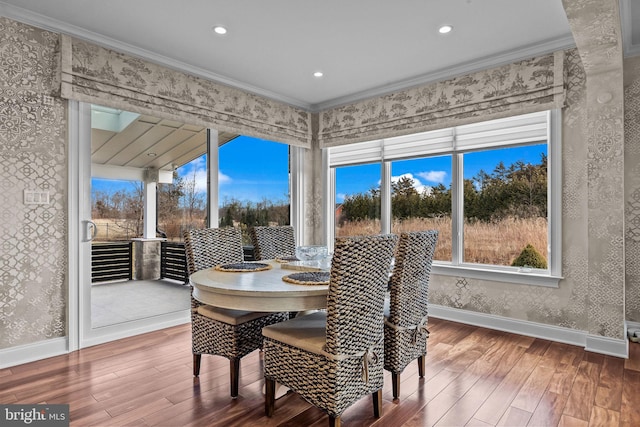 dining room featuring hardwood / wood-style floors and crown molding