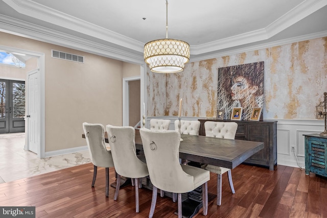 dining room featuring french doors, crown molding, and dark hardwood / wood-style floors