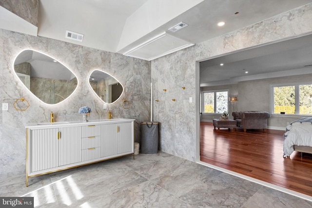 bathroom with vanity, hardwood / wood-style floors, and lofted ceiling