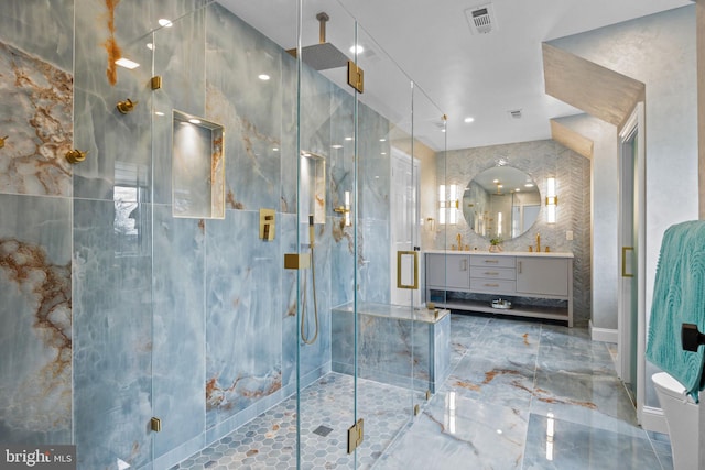 bathroom featuring vanity and a shower with door