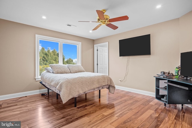 bedroom with ceiling fan and light hardwood / wood-style floors