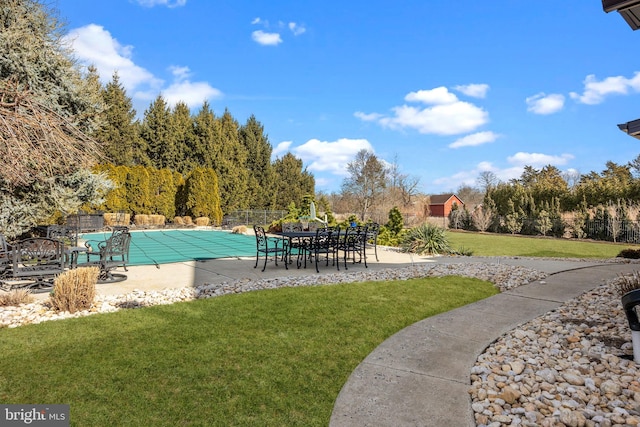 view of swimming pool featuring a patio and a lawn