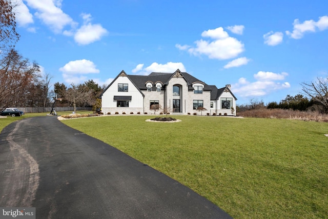 french provincial home featuring a front lawn