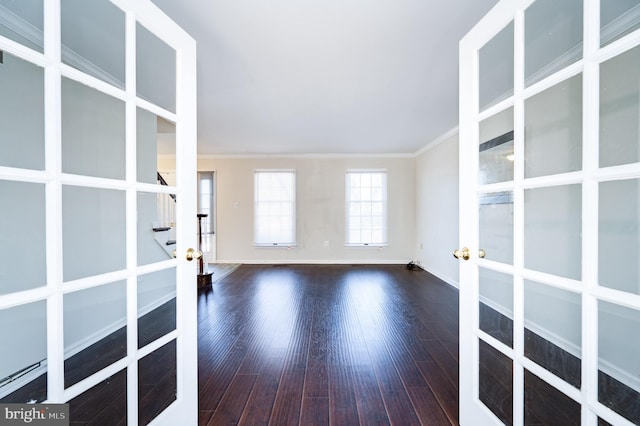 spare room with ornamental molding, dark wood-type flooring, and french doors