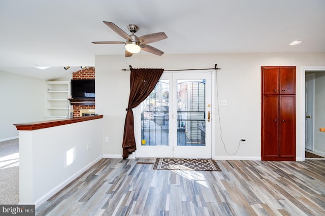 foyer entrance featuring ceiling fan and light hardwood / wood-style floors