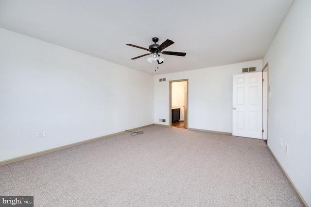 unfurnished bedroom featuring ensuite bathroom, ceiling fan, and carpet