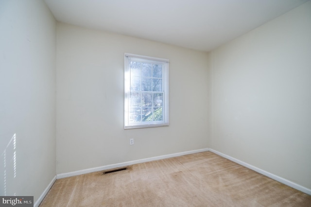 empty room featuring light colored carpet