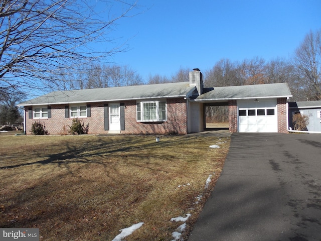 single story home with a garage and a front lawn