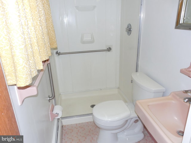 bathroom featuring sink, toilet, and walk in shower